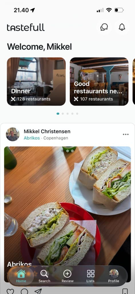 Tastefull home screen with discovery carousel and a restaurant review post.